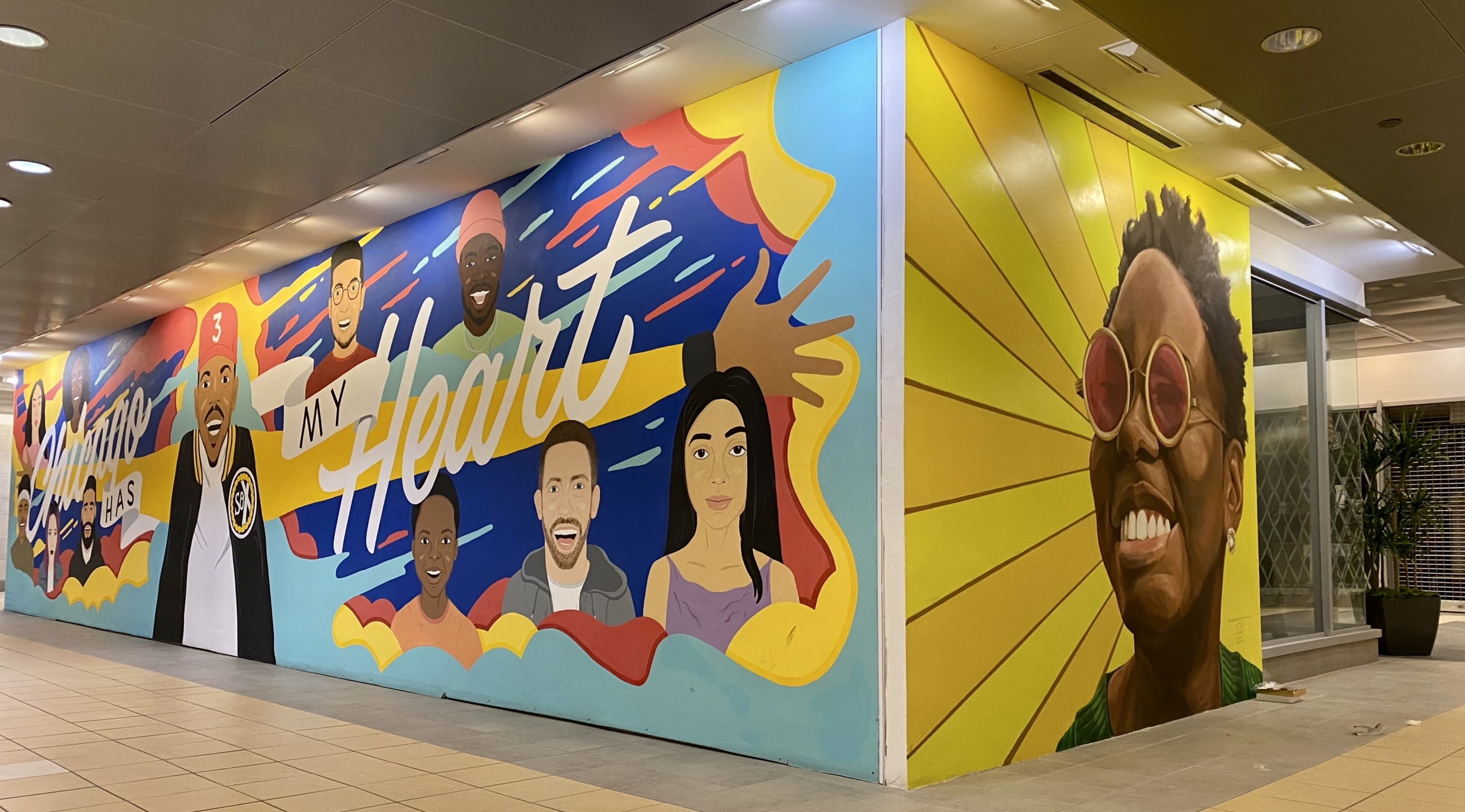 Mural celebrating influential creatives in Chicago made by SAIC undergraduate students Image description: Large mural with influential creatives in Chicago with the words Chicago has my heart painted across.